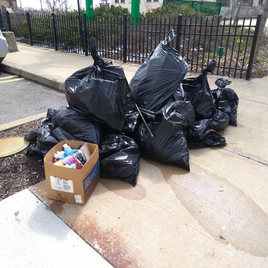 Pile of garbage bags on the sidewalk near Broadway Ave.